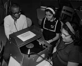 photo of students listening to a book recorded on an LP, circa 1960s