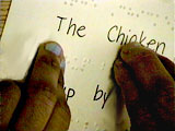 Closeup photo of fingers reading Braille