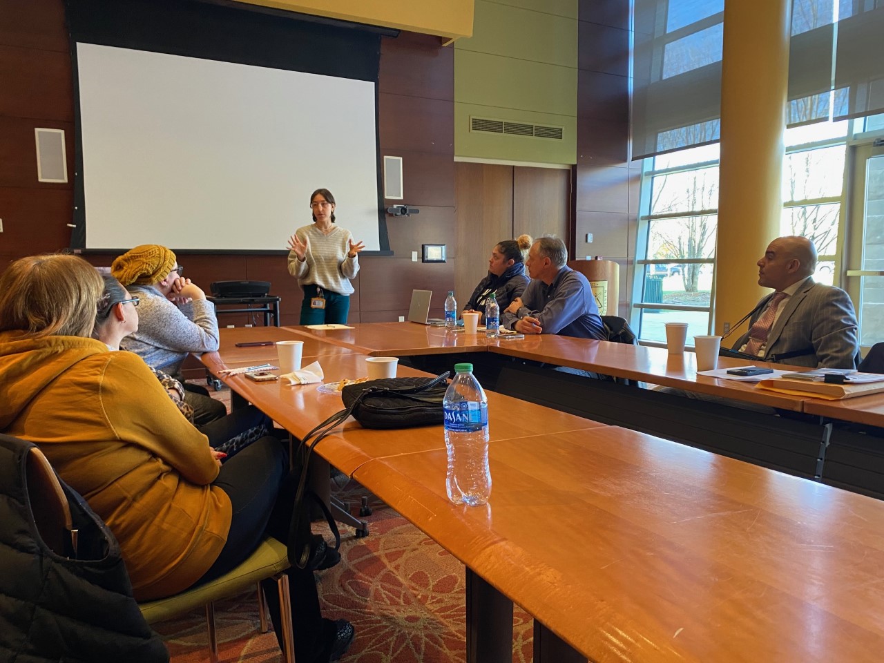 Photo of a woman addressing a group of people.