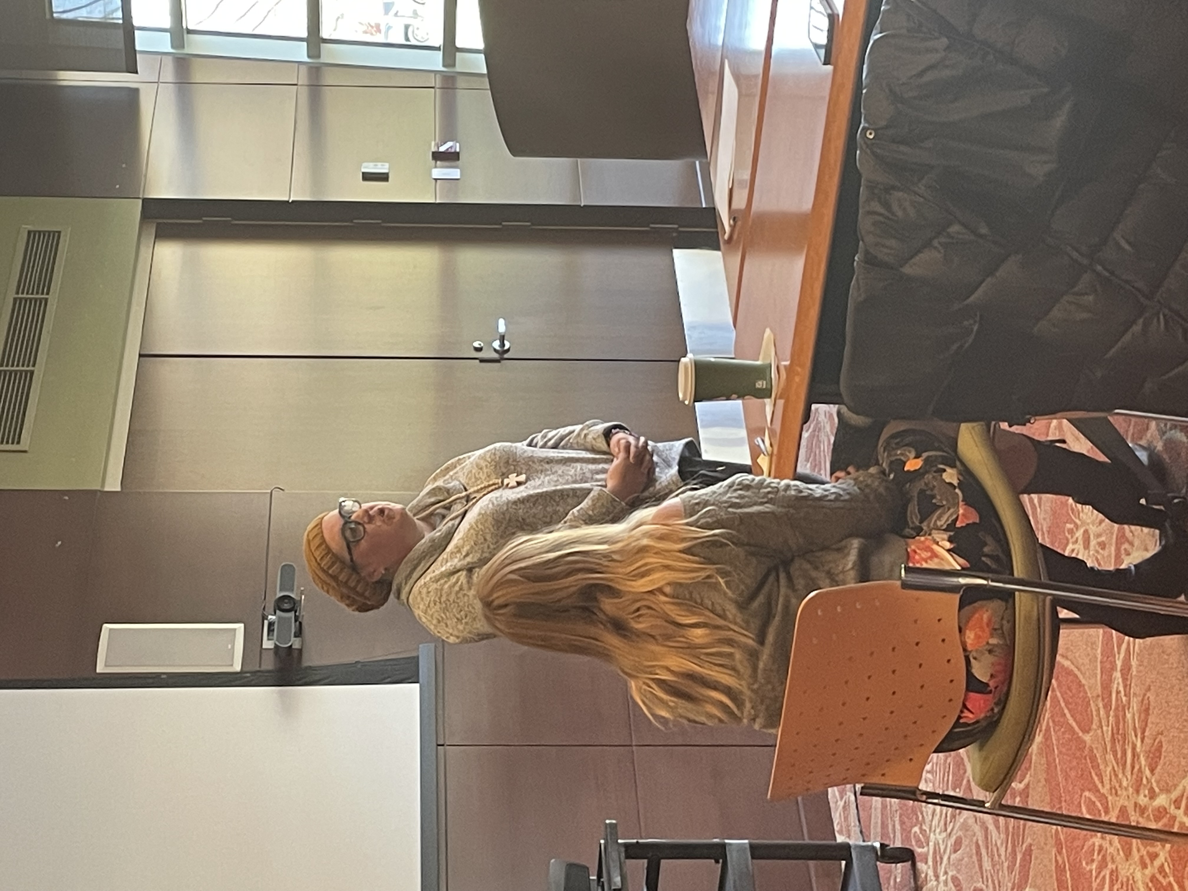 Photo of a woman addressing a group of people.