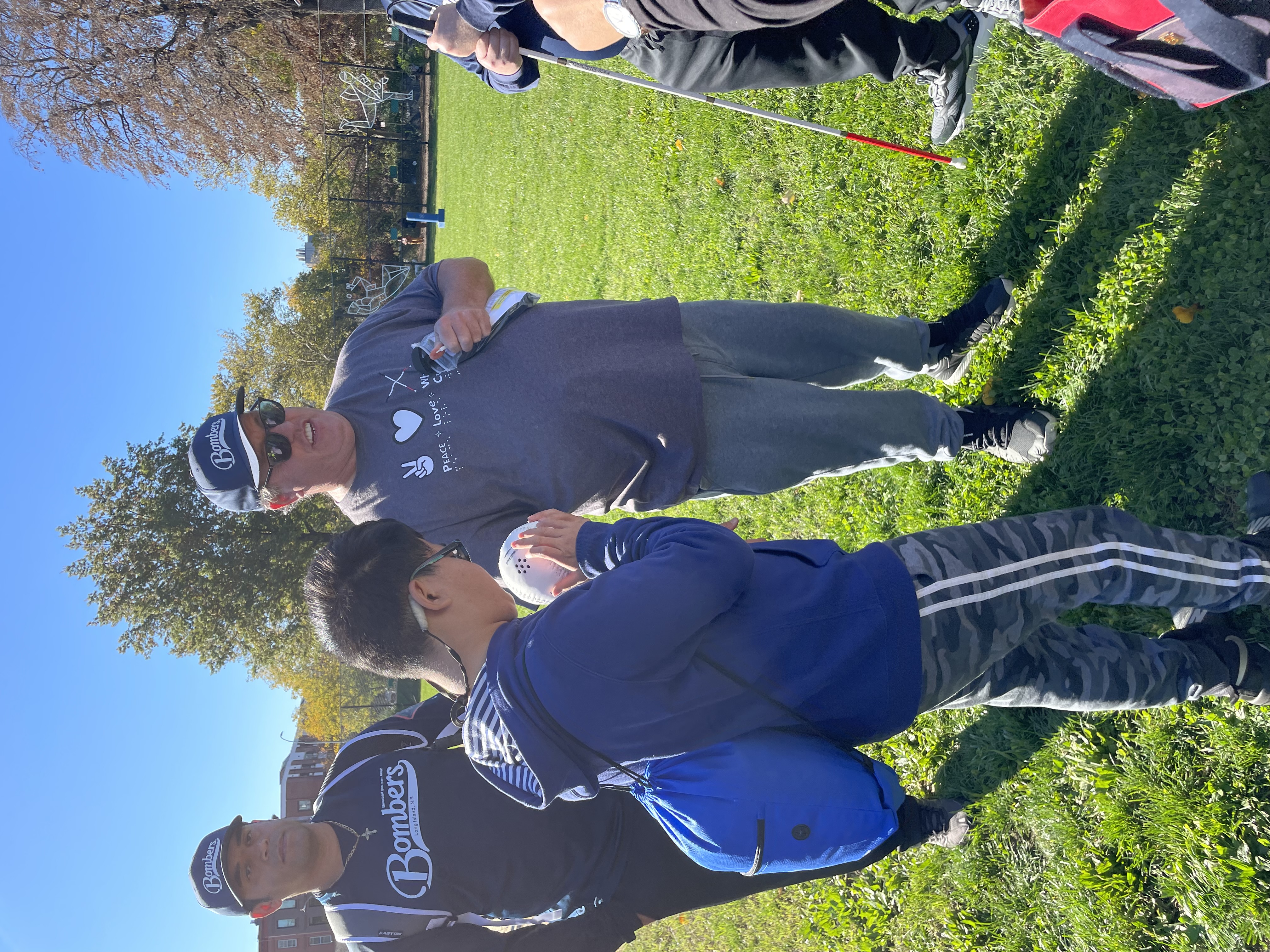 Photo of a group of people standing in a circle.